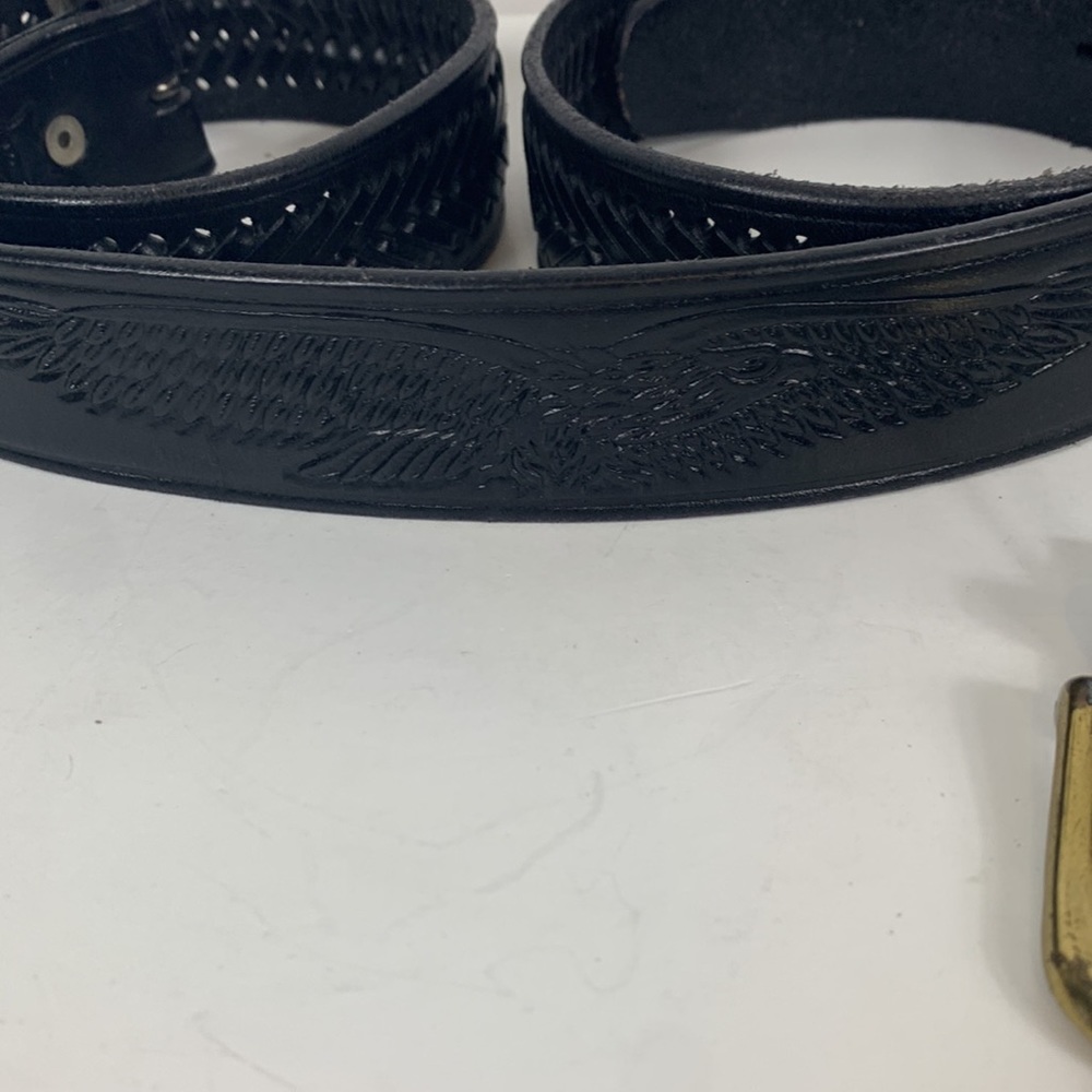 Genuine black leather belt size 46. Has eagle in back and V lace design.